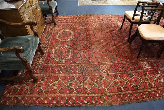 A large Persian carpet, 20ft 8in by 8ft 6in.